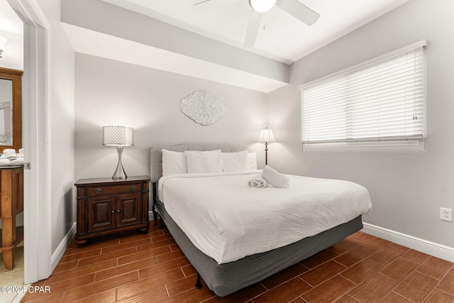 bedroom with ceiling fan, baseboards, and wood finish floors