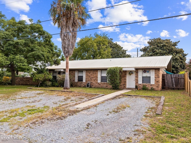 ranch-style home with a front yard