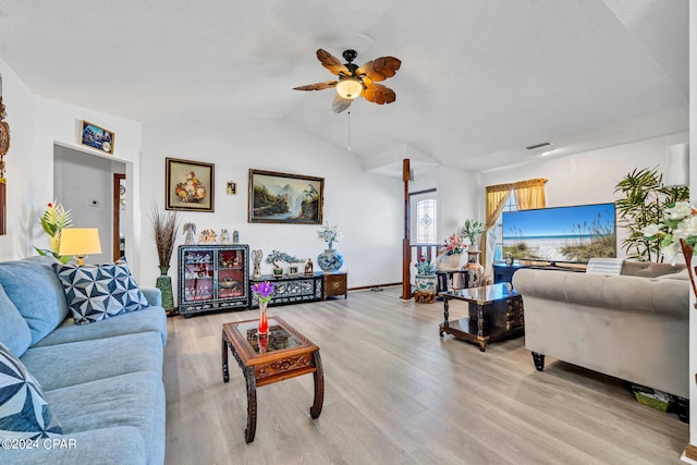 living room with ceiling fan, lofted ceiling, and light wood-type flooring