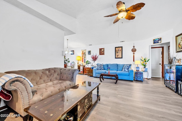 living room featuring ceiling fan and light hardwood / wood-style flooring