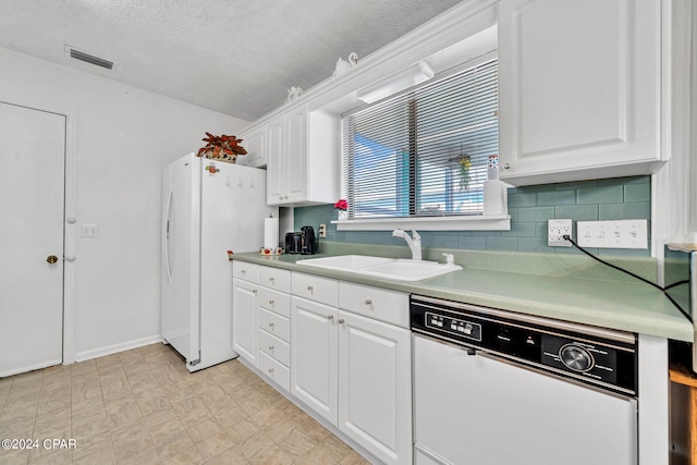 kitchen featuring a textured ceiling, white appliances, sink, and white cabinets