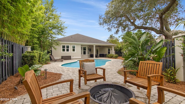 view of pool with a patio and a fire pit