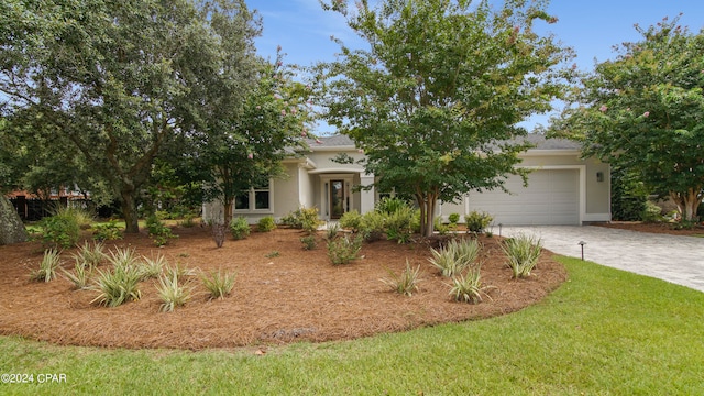 view of front of home featuring a front yard and a garage