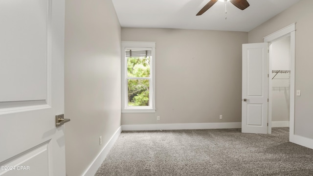 carpeted empty room featuring ceiling fan