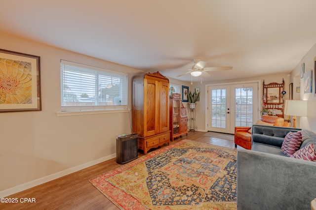 living room with ceiling fan, a healthy amount of sunlight, french doors, and hardwood / wood-style flooring