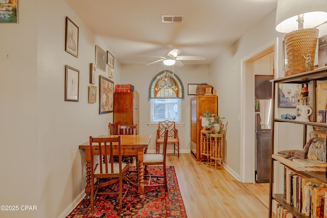 dining room with ceiling fan and light wood-type flooring