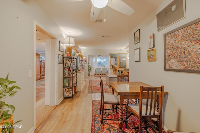 dining area with ceiling fan and light wood-type flooring