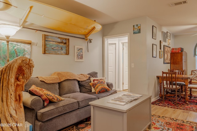 living room with ceiling fan and hardwood / wood-style floors