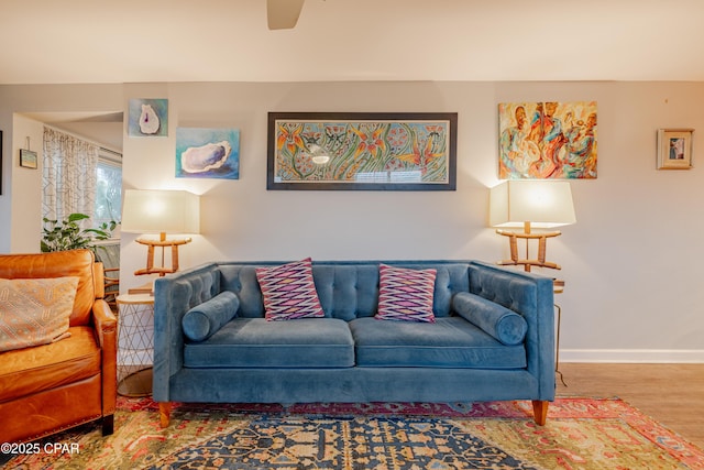 living room with ceiling fan and hardwood / wood-style flooring