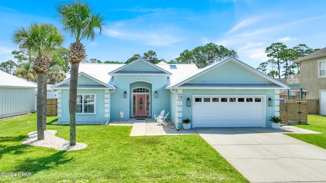 view of front of home featuring a front yard and a garage