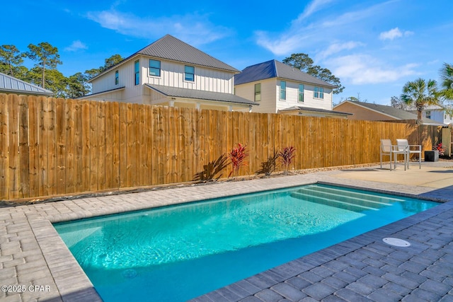 view of swimming pool with a patio area