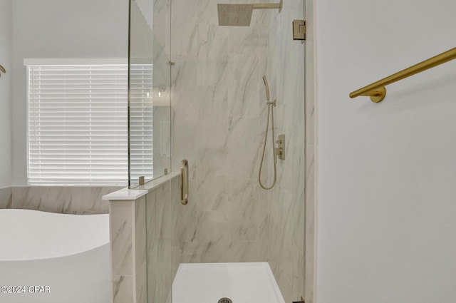 bathroom featuring shower with separate bathtub