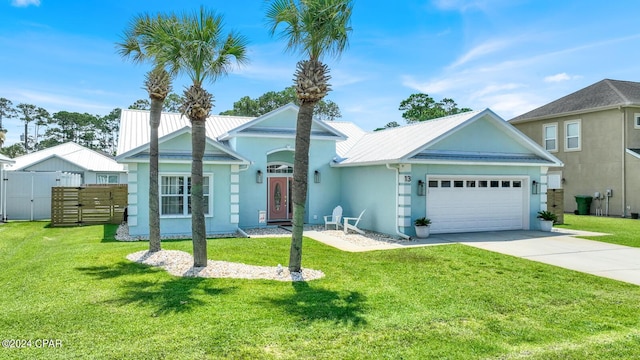 view of front of home featuring a front lawn and a garage