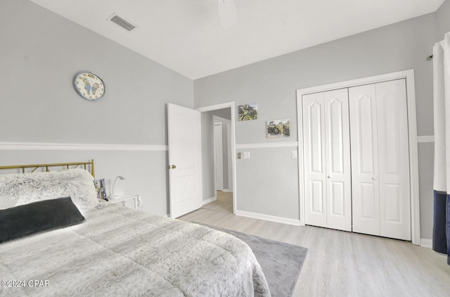 bedroom featuring ceiling fan, a closet, and light wood-type flooring