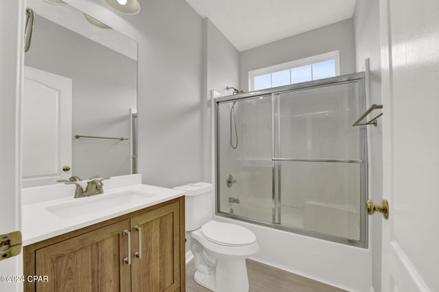 full bathroom with toilet, vanity, and combined bath / shower with glass door