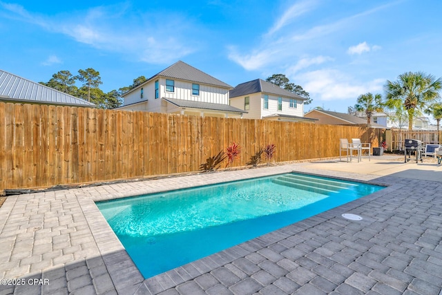 view of swimming pool with a patio area