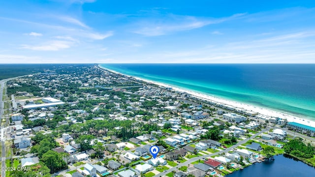 drone / aerial view with a water view and a beach view