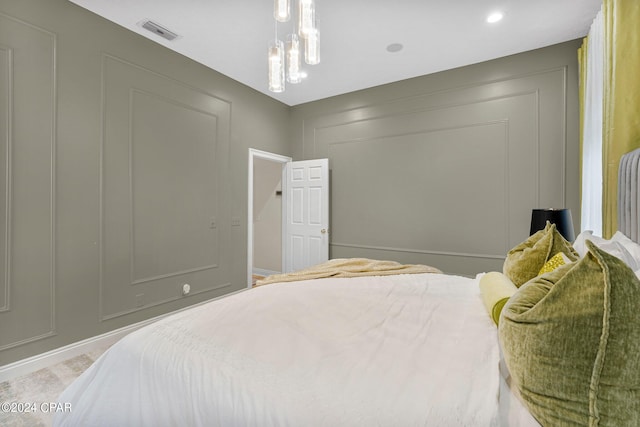 bedroom featuring an inviting chandelier