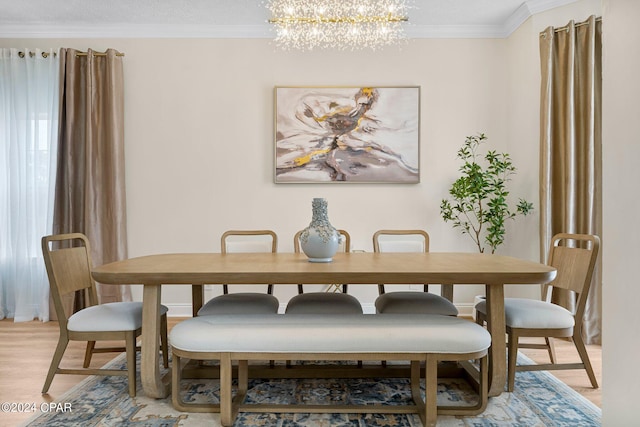 dining area with an inviting chandelier, crown molding, and light hardwood / wood-style flooring