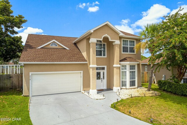 front of property with a garage and a front yard