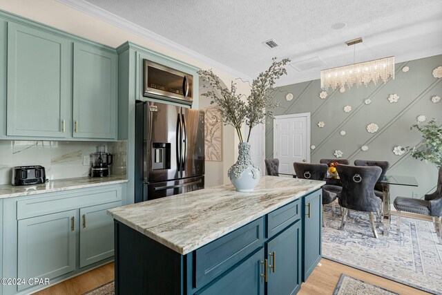 kitchen featuring crown molding, a textured ceiling, light wood-type flooring, light stone countertops, and stainless steel refrigerator with ice dispenser