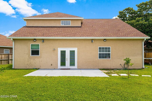 back of house with french doors, a lawn, and a patio area