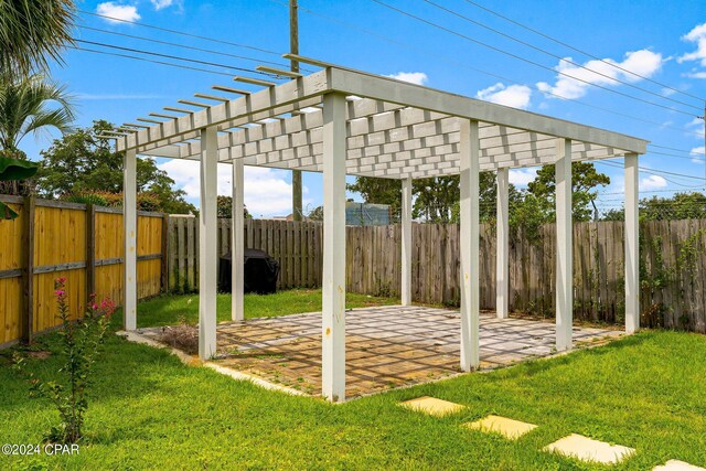 view of yard with a pergola and a patio