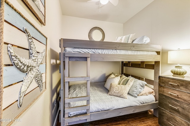 bedroom with dark hardwood / wood-style flooring and ceiling fan