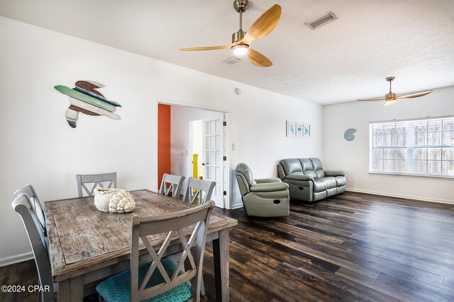 dining area featuring dark hardwood / wood-style flooring, a textured ceiling, and ceiling fan