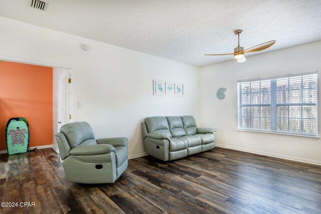 living room featuring hardwood / wood-style floors and ceiling fan