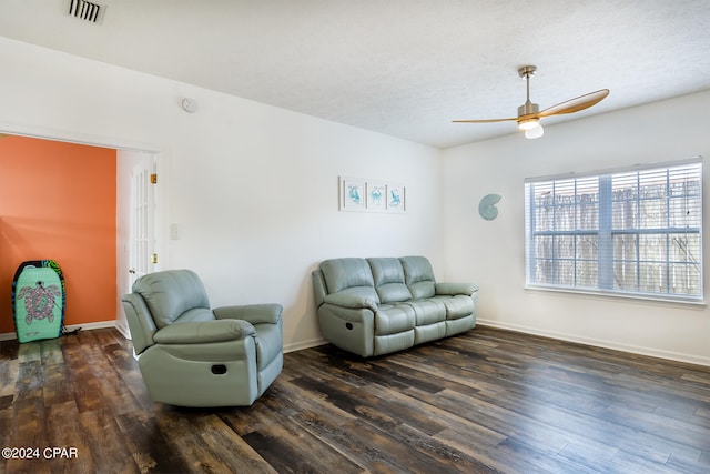 living area featuring a ceiling fan, wood finished floors, visible vents, and baseboards