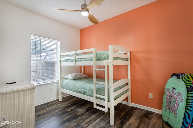 bedroom with a ceiling fan, baseboards, and wood finished floors