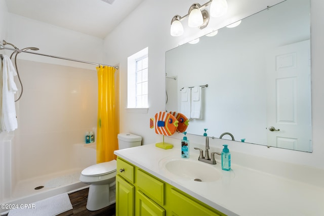 bathroom with a shower stall, toilet, and vanity