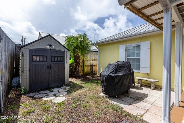 view of yard with a patio and a storage shed