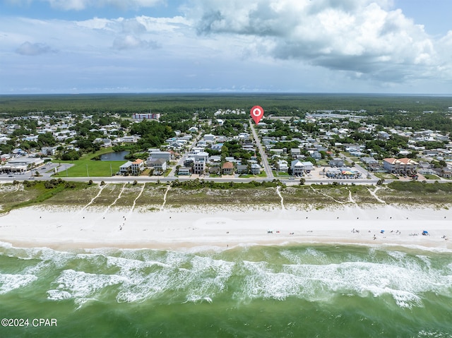 birds eye view of property with a view of the beach and a water view