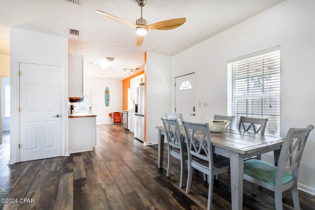 dining space featuring ceiling fan and dark wood-type flooring