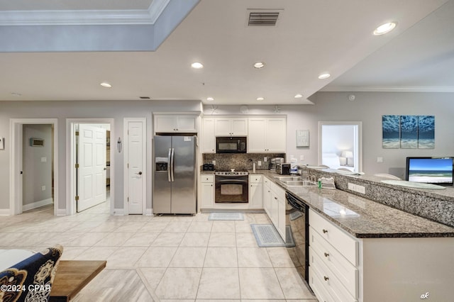 kitchen featuring crown molding, black appliances, light tile patterned floors, dark stone counters, and white cabinets