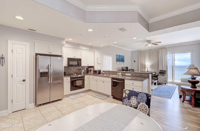 kitchen with white cabinetry, kitchen peninsula, and black appliances