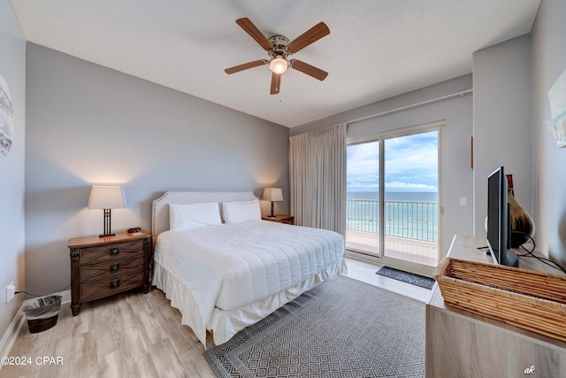 bedroom with access to exterior, ceiling fan, and light hardwood / wood-style flooring