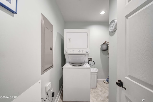 laundry room with stacked washing maching and dryer and electric panel