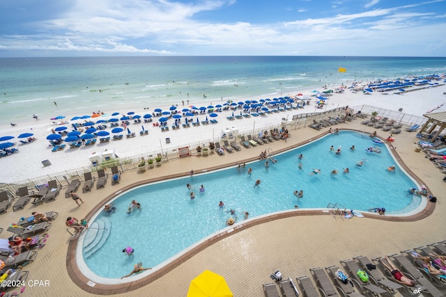 drone / aerial view with a water view and a beach view