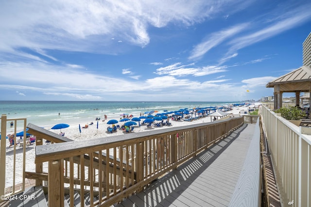 deck featuring a water view and a beach view