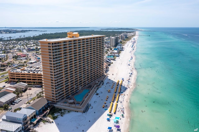 birds eye view of property with a water view and a view of the beach