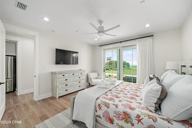 bedroom featuring access to outside, stainless steel refrigerator, ceiling fan, and light hardwood / wood-style flooring