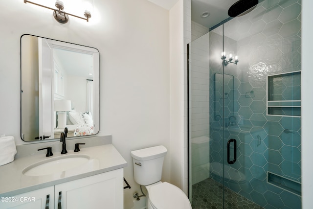 bathroom with walk in shower, vanity, and toilet