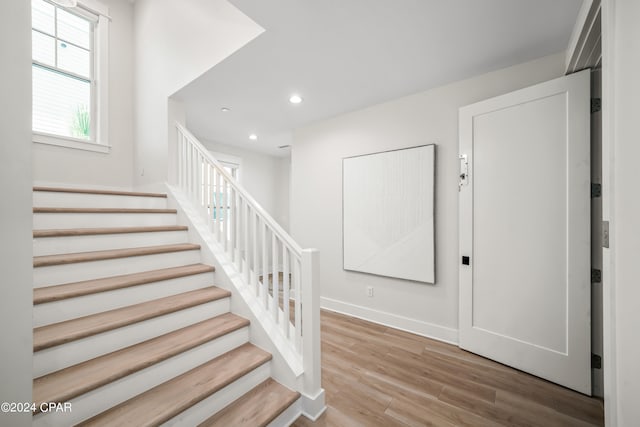 staircase with wood-type flooring