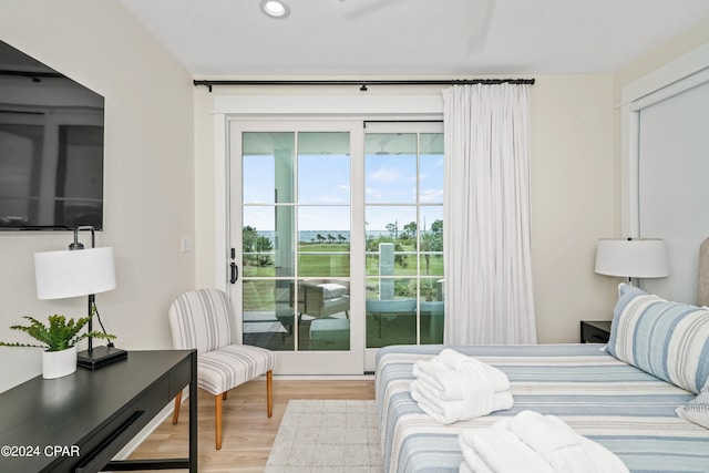 bedroom with light wood-type flooring and access to exterior