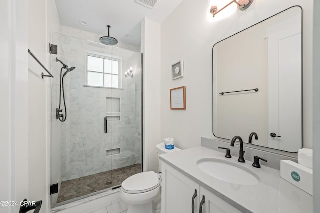 bathroom featuring tile patterned flooring, vanity, toilet, and an enclosed shower