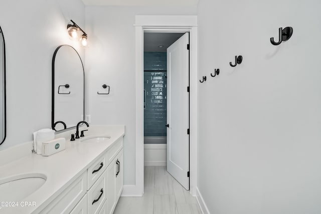 bathroom with enclosed tub / shower combo and vanity