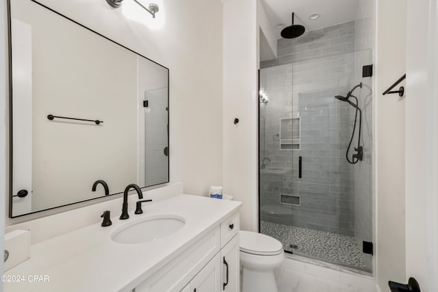 bathroom featuring walk in shower and vanity